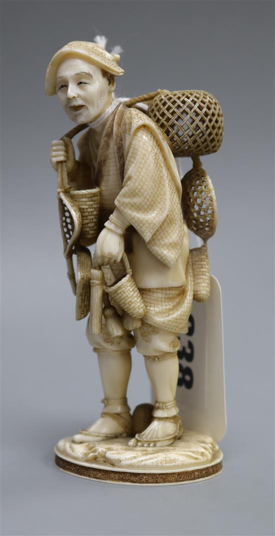 A Japanese ivory basket seller height 11cm